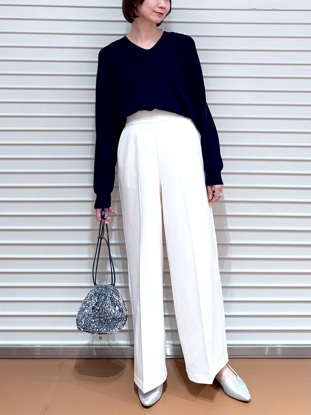 ブルー系のニット/セーター、シルバー系のパンプスを着用したレディースの春コーディネートの5枚目の写真