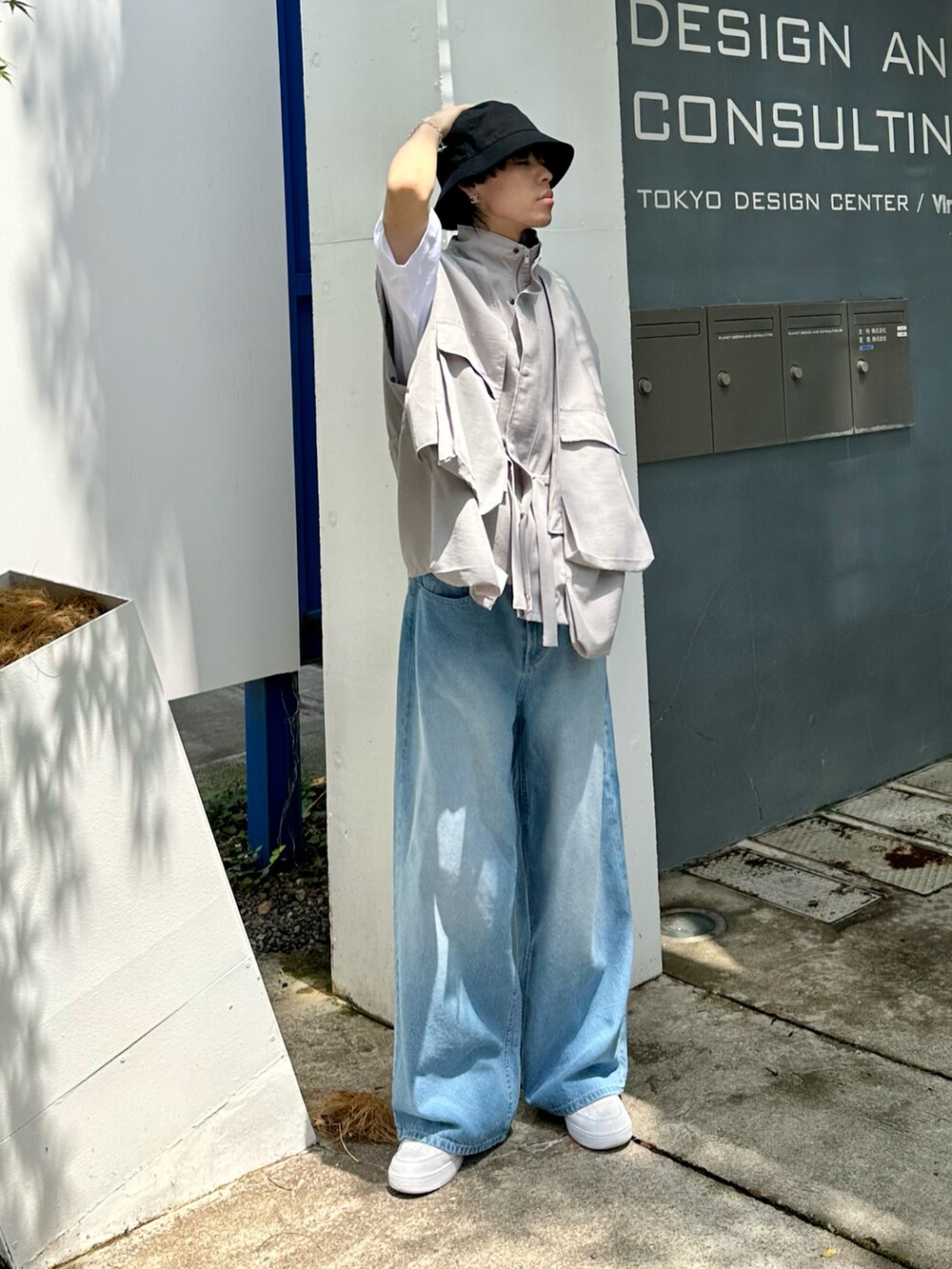 ブルー系のデニムパンツ、ホワイト系のTシャツ/カットソー、ホワイト系のスニーカーを着用したメンズの夏コーディネートの2枚目の写真