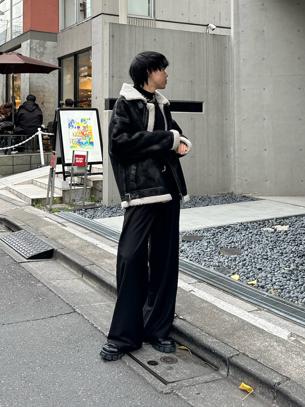 ブラック系のムートンコート、ブラック系のニット/セーターを着用したメンズの冬コーディネートの2枚目の写真