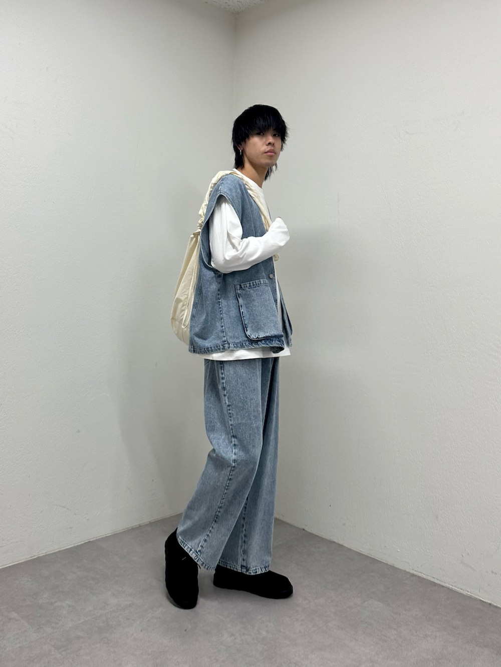 ブルー系のベスト、ブルー系のデニムパンツ、ホワイト系のTシャツ/カットソーを着用したメンズの春コーディネートの3枚目の写真