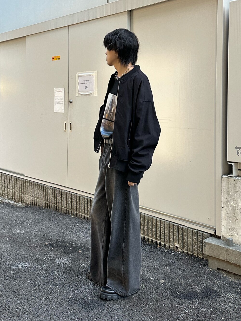 ブラック系のMA-1、ブラック系のデニムパンツ、ブラック系のTシャツ/カットソーを着用したメンズの冬コーディネートの2枚目の写真