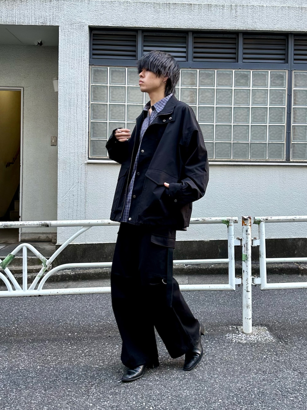 ブラック系のブルゾン、ブルー系のシャツ/ブラウス、ブラック系のカーゴパンツを着用したメンズの秋コーディネートの2枚目の写真