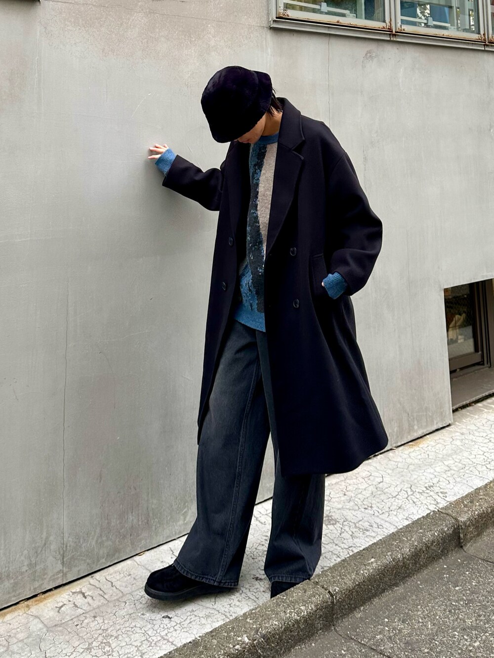 ブラック系のその他アウター、ブラック系のデニムパンツ、ブルー系のニット/セーターを着用したメンズの冬コーディネートの4枚目の写真