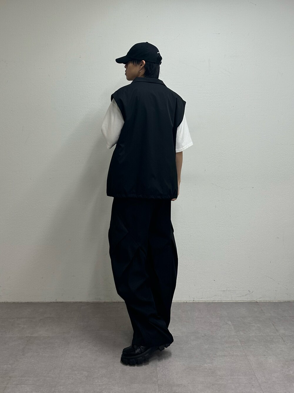 ブラック系のベスト、ホワイト系のTシャツ/カットソー、ブラック系のその他パンツを着用したメンズの夏コーディネートの3枚目の写真