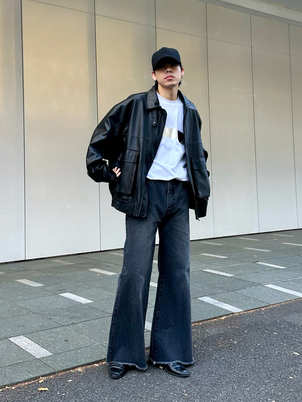 ブラック系のブルゾン、ブラック系のデニムパンツ、ホワイト系のTシャツ/カットソーを着用したメンズの冬コーディネートの5枚目の写真