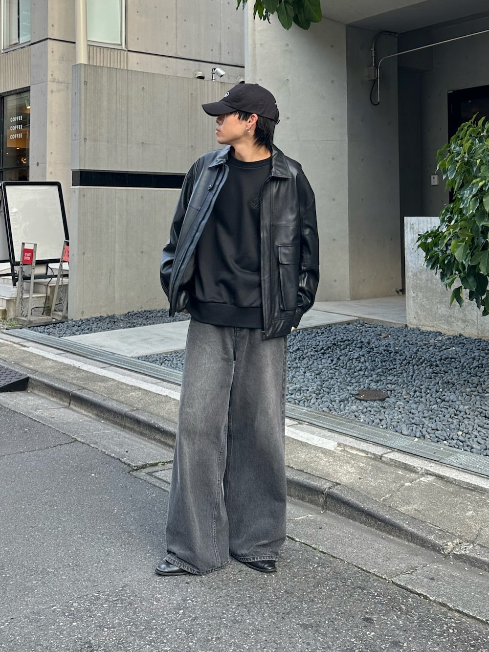 ブラック系のTシャツ/カットソー、ブラック系のデニムパンツ、ブラック系のブルゾンを着用したメンズの秋コーディネートの2枚目の写真