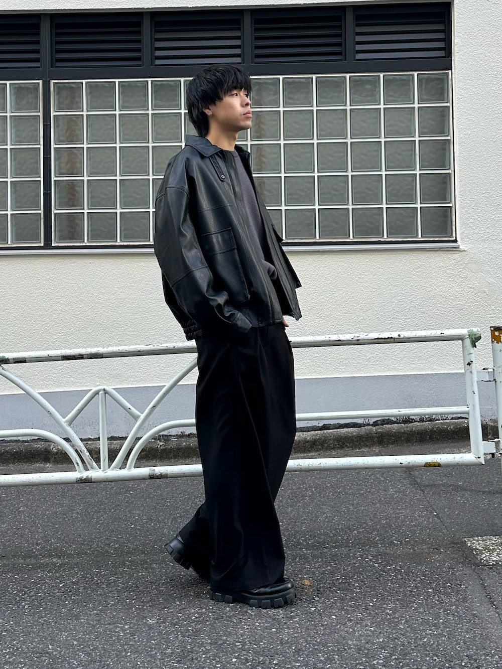 ブラック系のブルゾン、グレー系のニット/セーター、ブラック系のベルトを着用したメンズの冬コーディネートの2枚目の写真