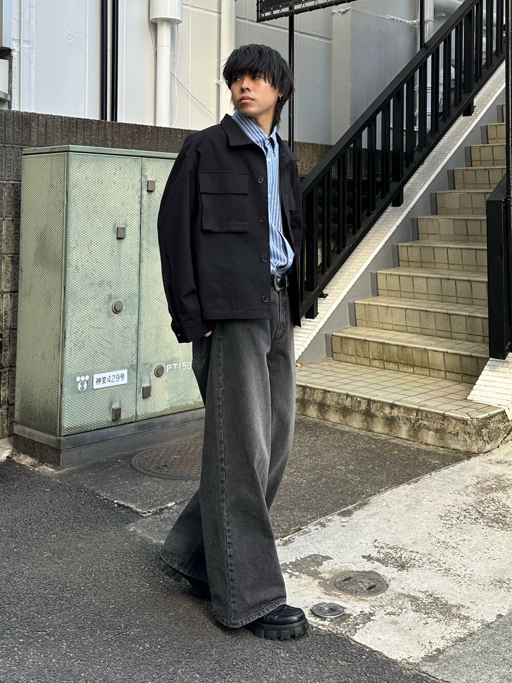 ブラック系のその他アウター、ブラック系のデニムパンツ、ブラック系のベルトを着用したメンズの冬コーディネートの4枚目の写真