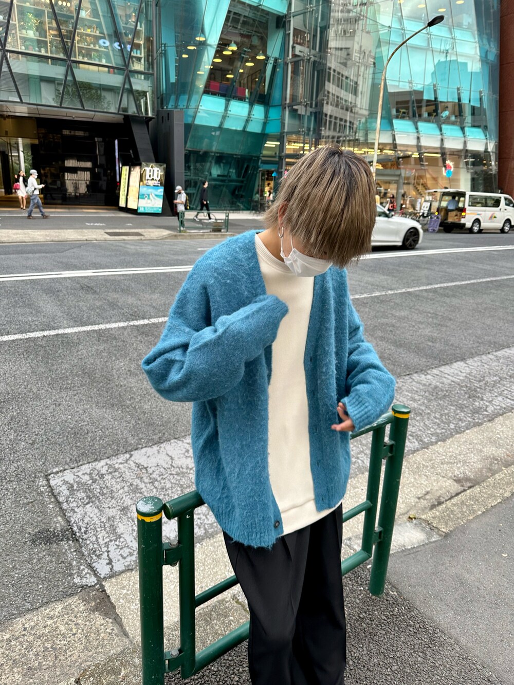 ブルー系のカーディガン/ボレロ、ホワイト系のTシャツ/カットソー、ブラック系のスラックスを着用したメンズの秋コーディネートの5枚目の写真