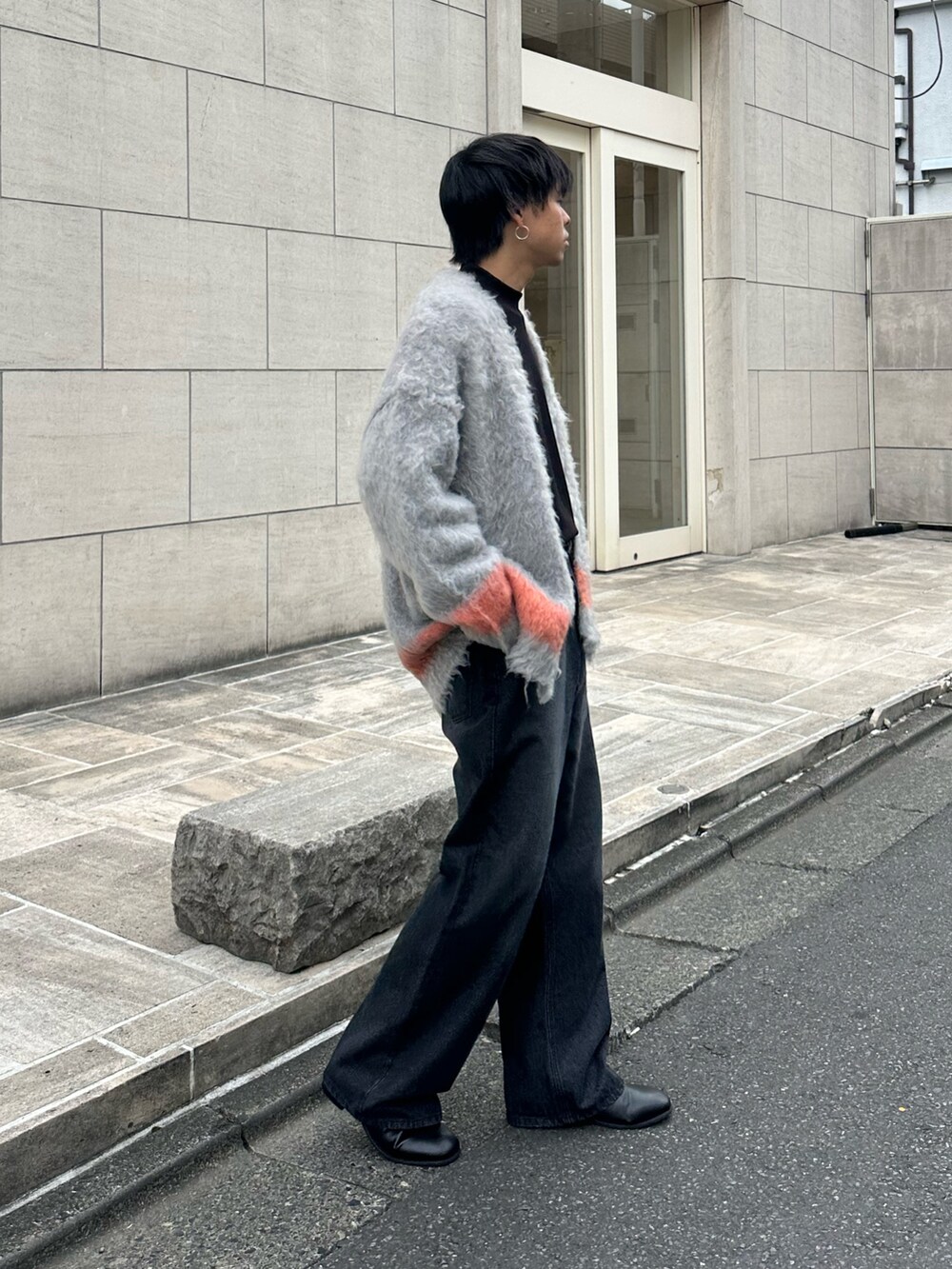 ブラック系のカーディガン/ボレロ、ブラック系のTシャツ/カットソー、ブラック系のデニムパンツを着用したメンズの秋コーディネートの4枚目の写真