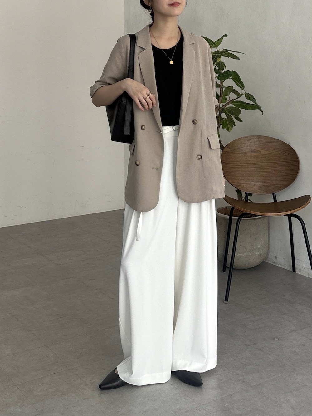 ブラック系のワンピース、ホワイト系のその他パンツ、ベージュ系のテーラードジャケットを着用したレディースの夏コーディネートの2枚目の写真