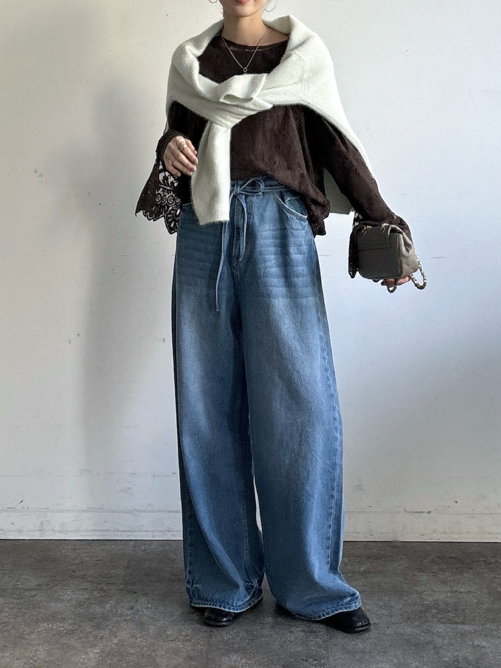 ブルー系のデニムパンツ、ブラウン系のシャツ/ブラウス、ブラウン系のTシャツ/カットソーを着用したレディースの冬コーディネートの5枚目の写真