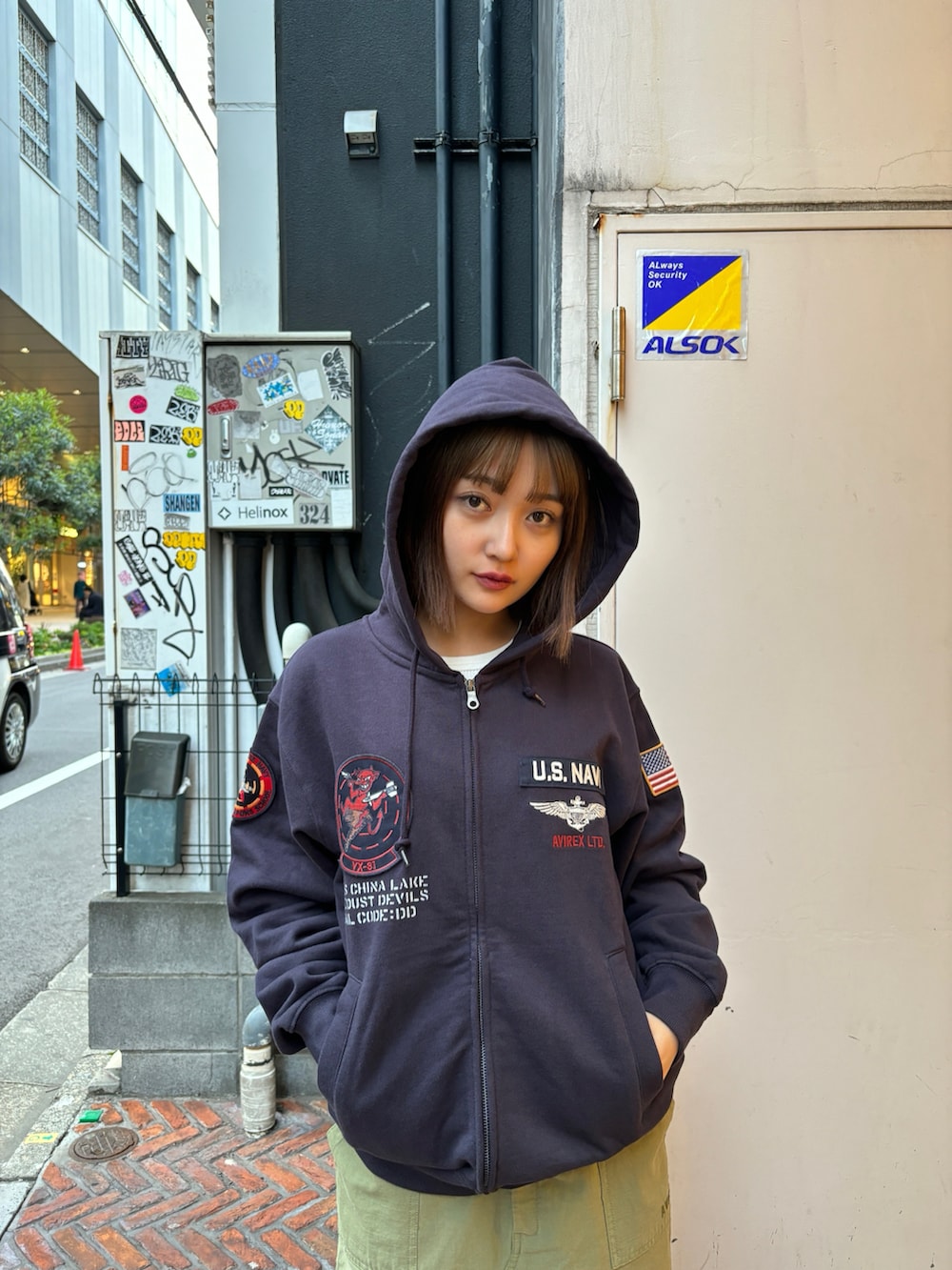 ブルー系のパーカー、グリーン系のスカートを着用したレディースの春コーディネートの4枚目の写真