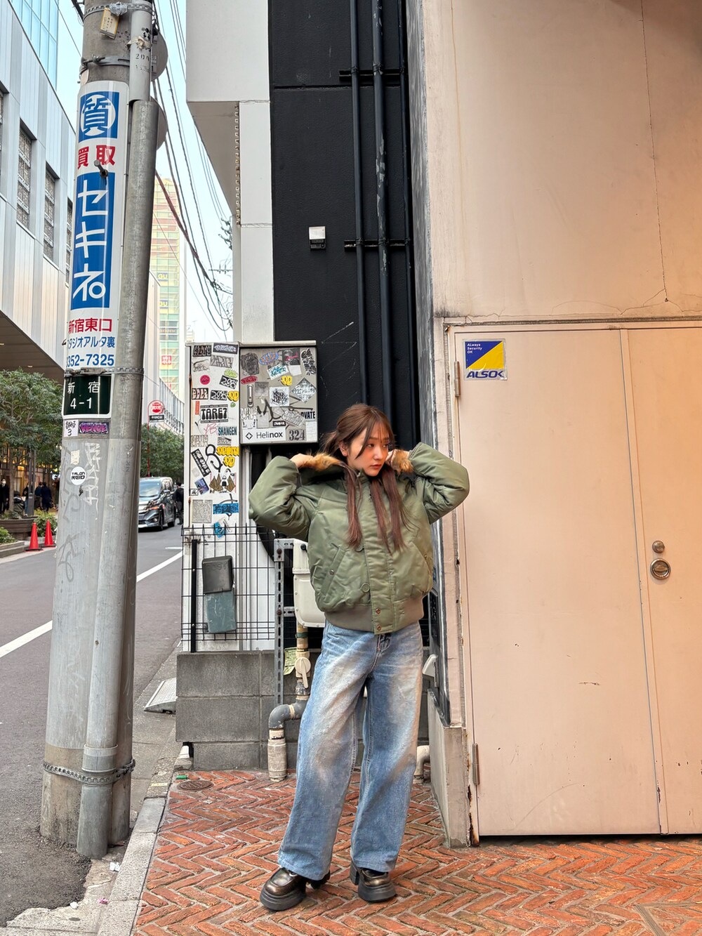 グリーン系のミリタリージャケットを着用したレディースの冬コーディネートの3枚目の写真