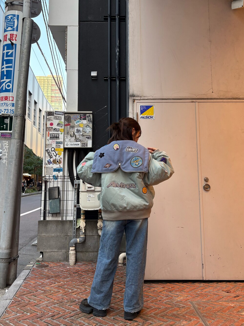 グリーン系のミリタリージャケットを着用したレディースの冬コーディネートの2枚目の写真