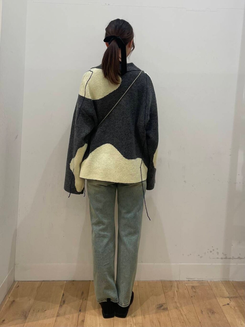 ブラック系のショルダーバッグ、ブルー系のその他パンツ、ホワイト系のTシャツ/カットソーを着用したレディースの秋コーディネートの3枚目の写真