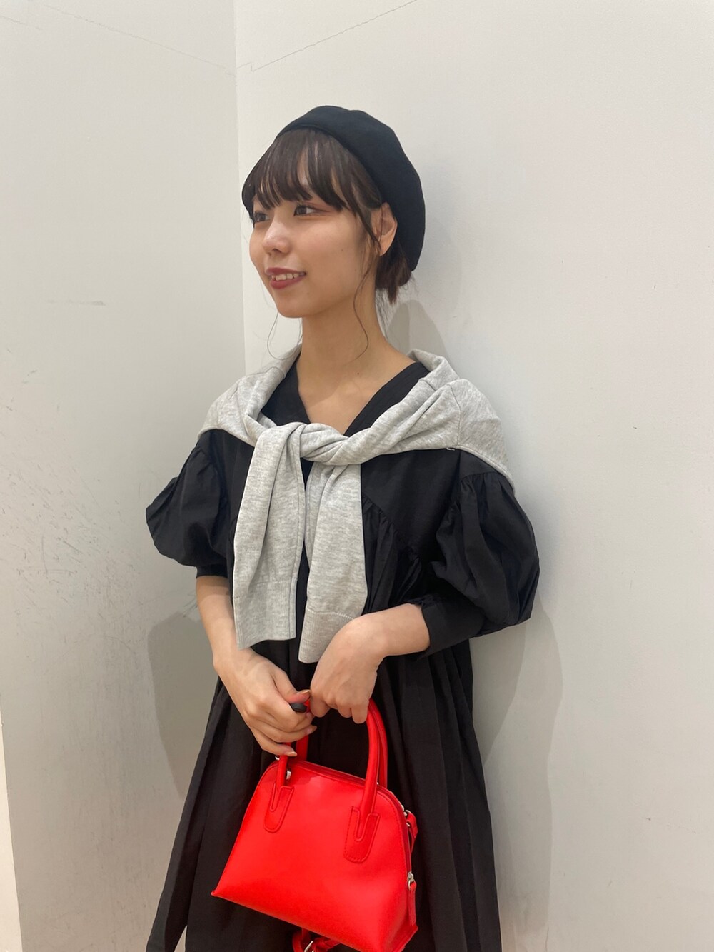 グレー系のカーディガン/ボレロ、ブラック系のその他パンツ、レッド系のショルダーバッグを着用したレディースの春コーディネートの4枚目の写真