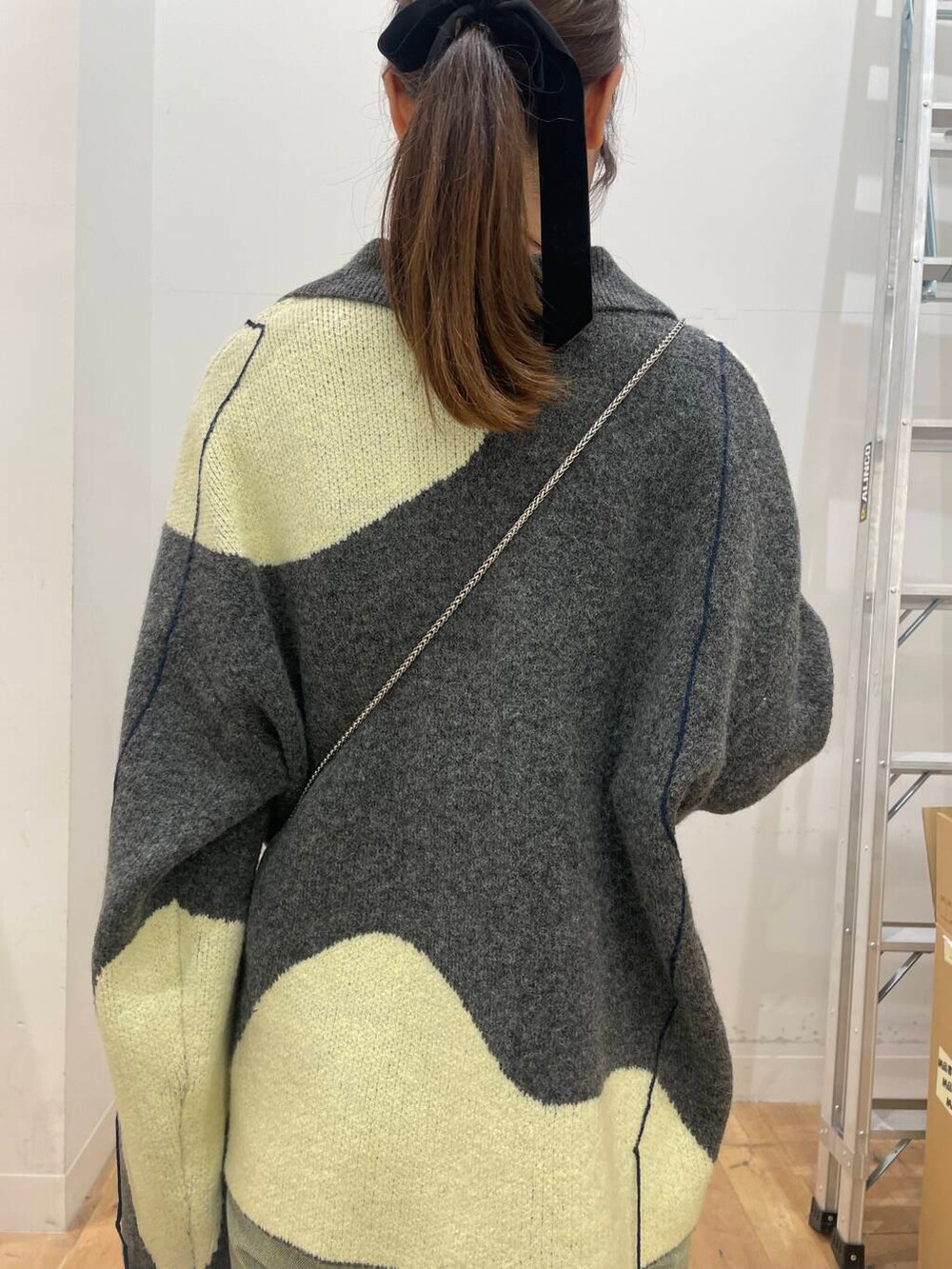 ブラック系のショルダーバッグ、ブルー系のその他パンツ、ホワイト系のTシャツ/カットソーを着用したレディースの秋コーディネートの5枚目の写真