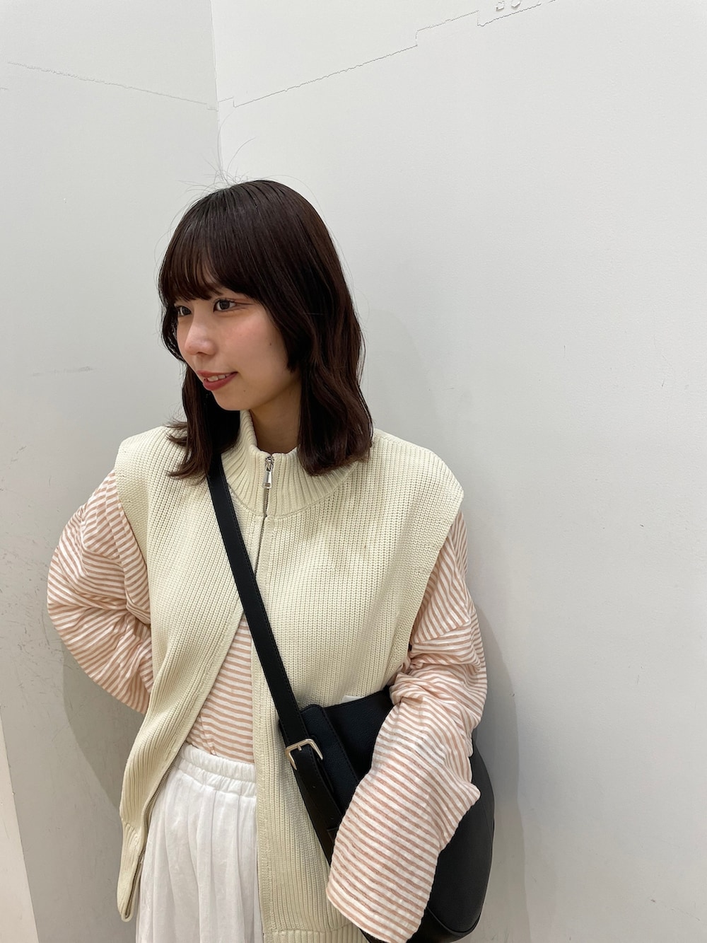 ホワイト系のスカート、ホワイト系のベスト、ピンク系のTシャツ/カットソーを着用したレディースの春コーディネートの4枚目の写真