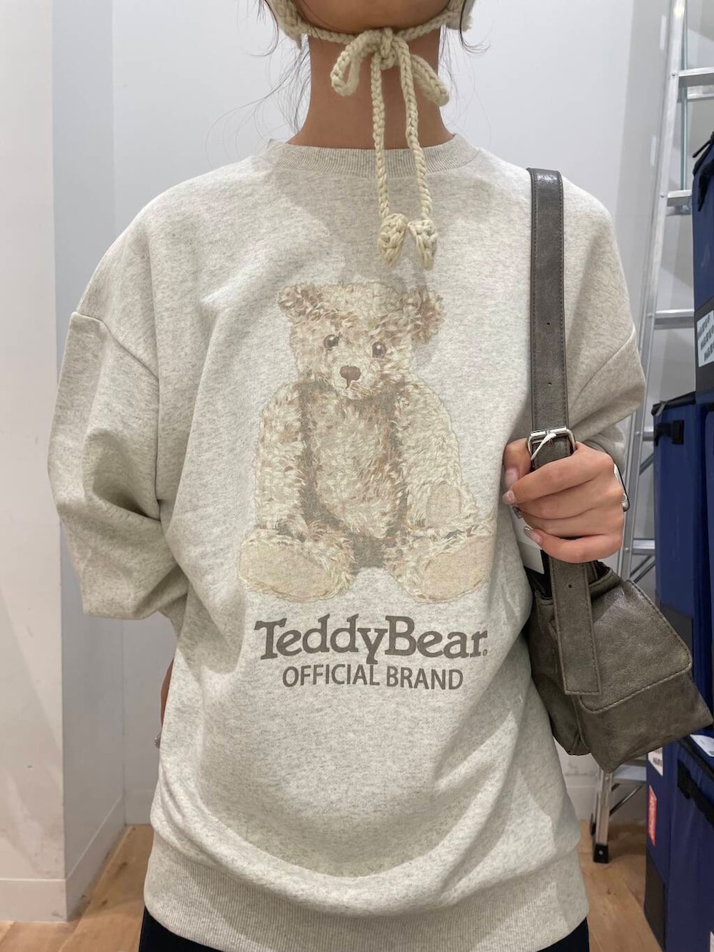 ブラウン系のブーツ、グレー系のハンドバッグ、ブルー系のスカートを着用したレディースの秋コーディネートの4枚目の写真