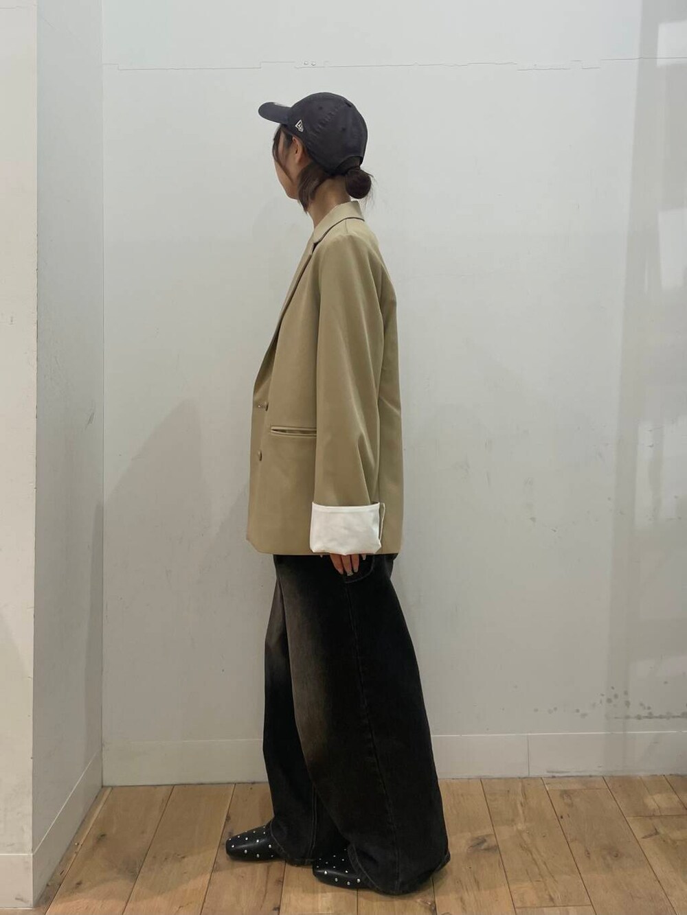 ベージュ系のパンプス、ブラック系のデニムパンツ、ベージュ系のテーラードジャケットを着用したレディースの冬コーディネートの2枚目の写真