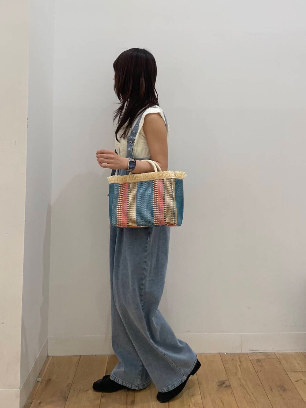 ベージュ系のショルダーバッグ、ホワイト系のTシャツ/カットソーを着用したレディースの春コーディネートの2枚目の写真