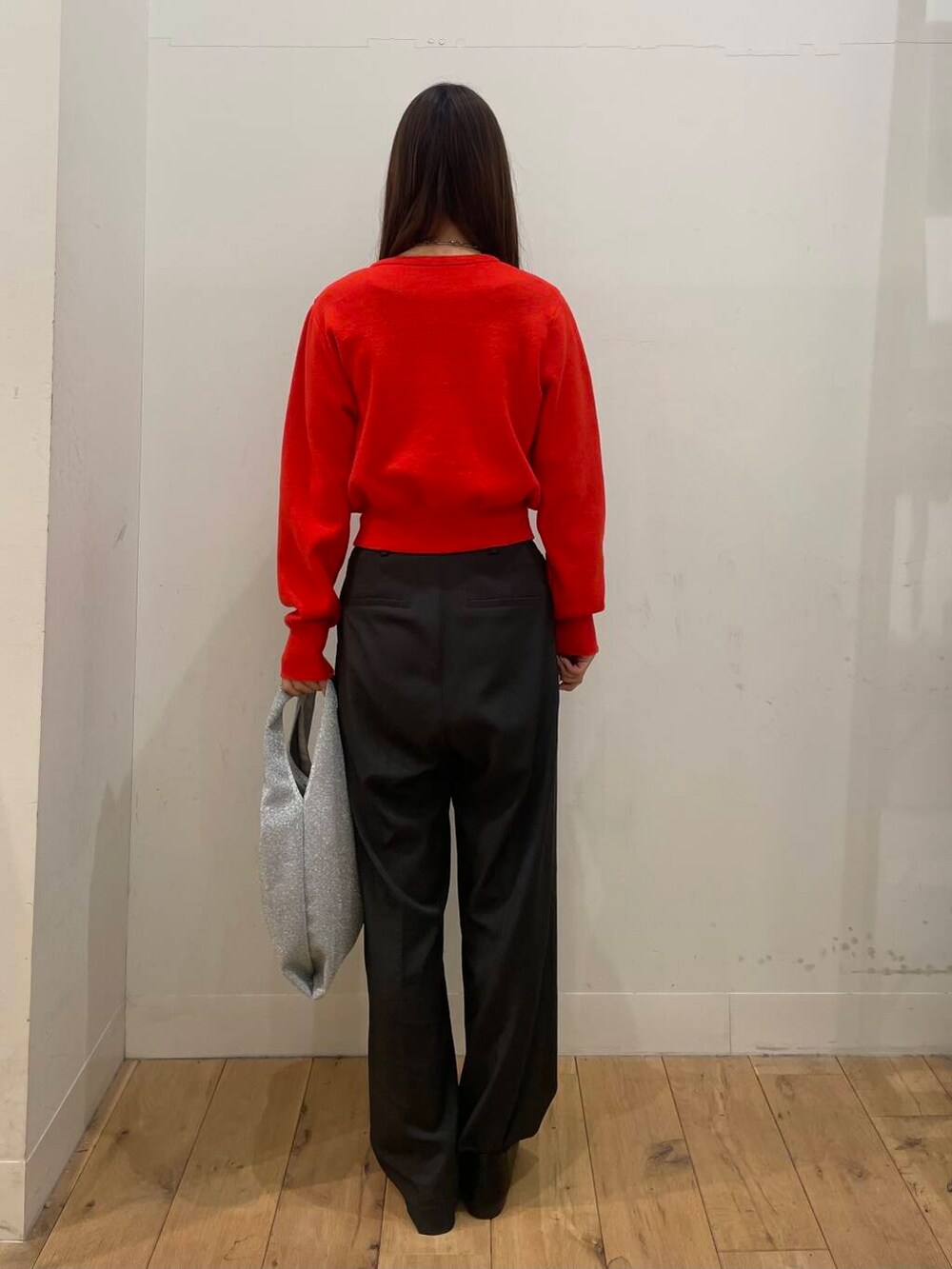 シルバー系のトートバッグ、レッド系のカーディガン/ボレロ、グレー系のその他パンツを着用したレディースの冬コーディネートの3枚目の写真