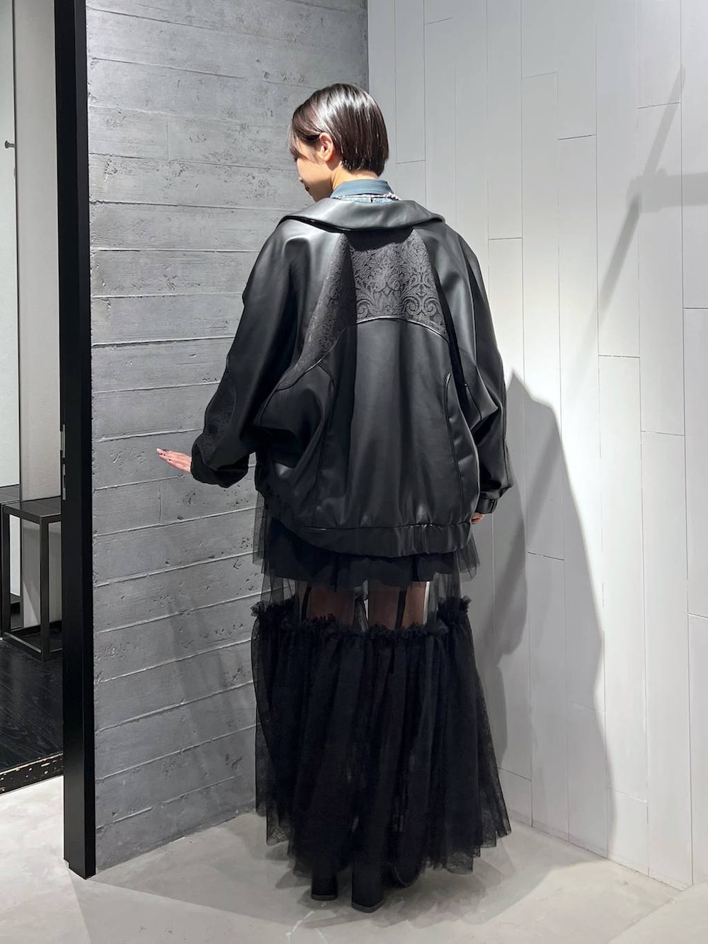 ブラック系のネクタイ、ブラック系のブルゾン、ブラック系のその他パンツを着用したレディースの秋コーディネートの6枚目の写真