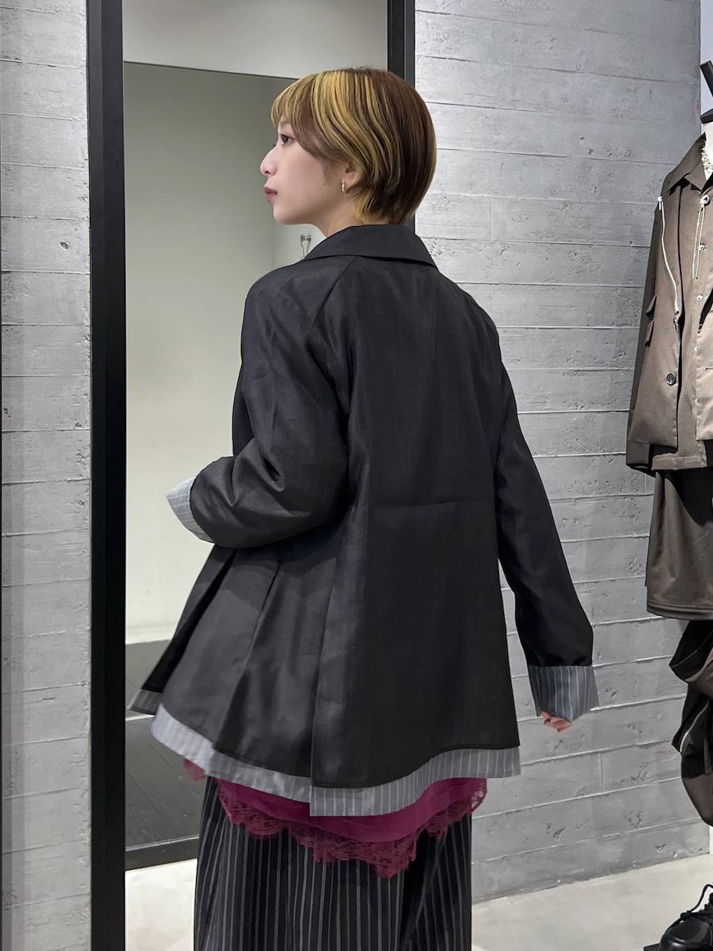 ブラック系のブーツ、ピンク系のTシャツ/カットソー、ブラック系のスラックスを着用したレディースの春コーディネートの3枚目の写真