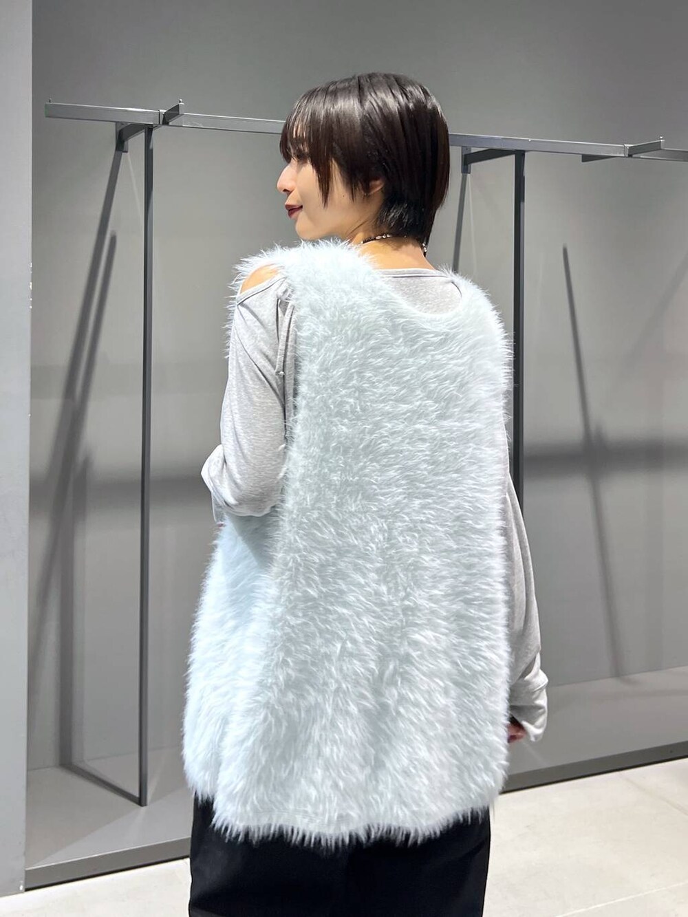 グリーン系のカーディガン/ボレロ、グレー系のTシャツ/カットソー、ブラック系のブーツを着用したレディースの秋コーディネートの3枚目の写真