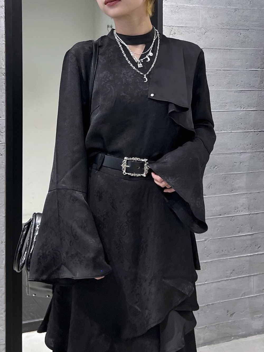 ブラック系のブーツ、ブラック系のショルダーバッグ、ブラック系のシャツ/ブラウスを着用したレディースの春コーディネートの2枚目の写真