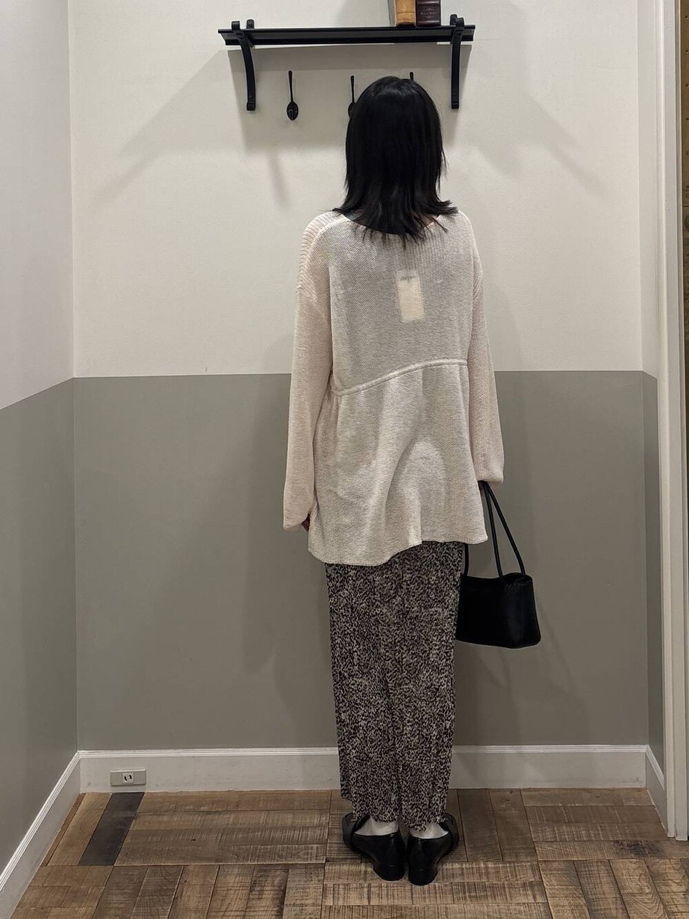 ベージュ系のスカート、ブラック系のローファー、ブラック系のショルダーバッグを着用したレディースの春コーディネートの3枚目の写真