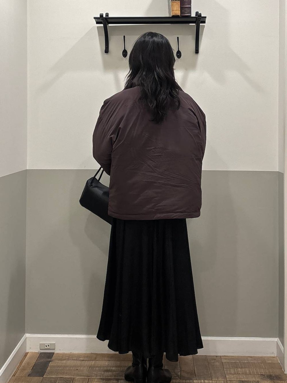 ブラック系のブーツ、ブラウン系のブルゾン、ブラック系のスカートを着用したレディースの冬コーディネートの2枚目の写真