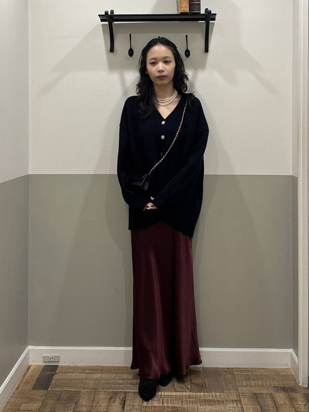 ブルー系のカーディガン/ボレロ、レッド系のスカート、ブラック系のブーツを着用したレディースの秋コーディネートの2枚目の写真