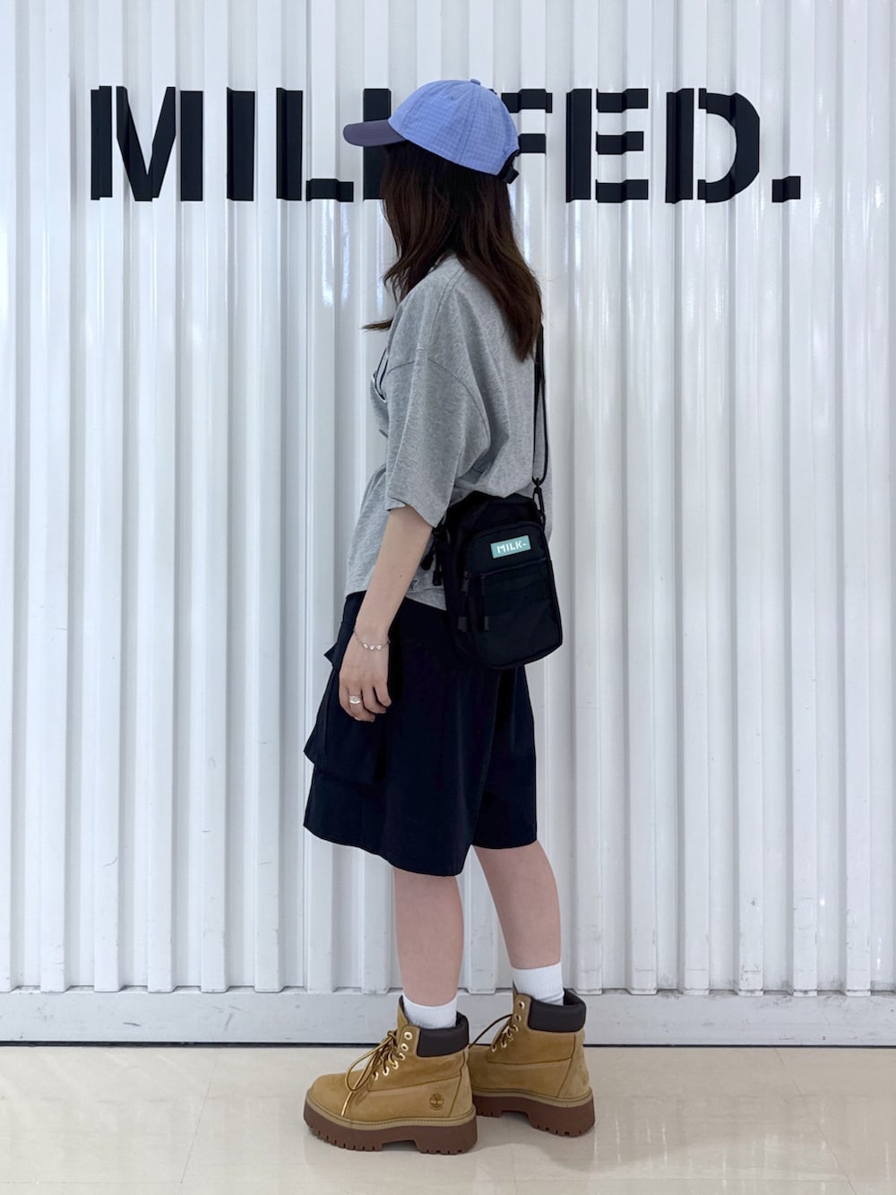 グレー系のTシャツ/カットソー、ブラック系のその他パンツ、グリーン系のショルダーバッグを着用したレディースの夏コーディネートの2枚目の写真