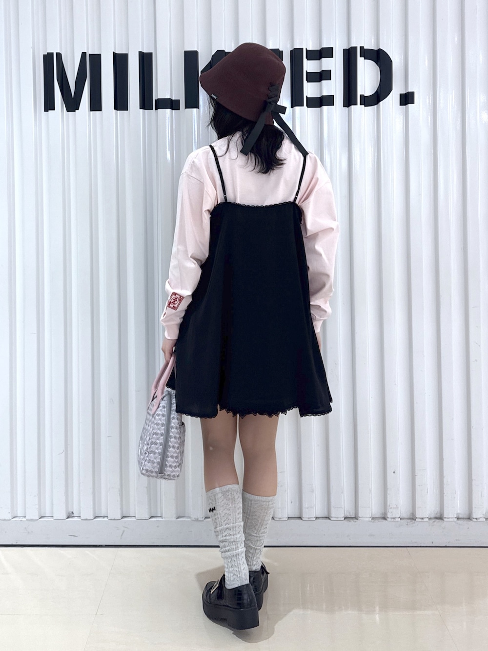 ブラック系のキャミソール、ピンク系のTシャツ/カットソー、ブラック系のスカートを着用したレディースの春コーディネートの3枚目の写真