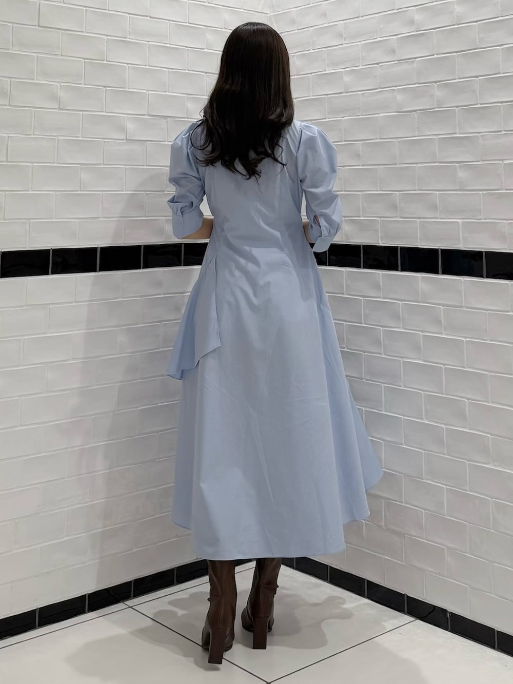 ブルー系のワンピース、ブラウン系のブーツを着用したレディースの春コーディネートの5枚目の写真