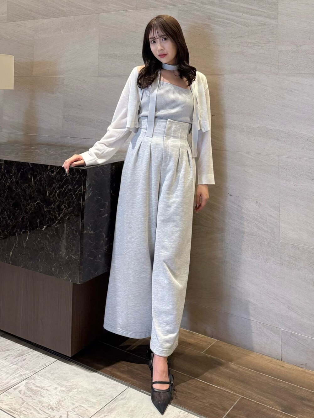 グレー系のニット/セーター、グレー系のその他パンツ、ブラック系のパンプスを着用したレディースの春コーディネートの3枚目の写真