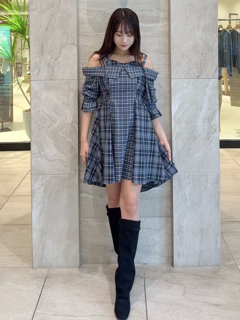 ブルー系のワンピース、ブラック系のブーツを着用したレディースの秋コーディネートの6枚目の写真