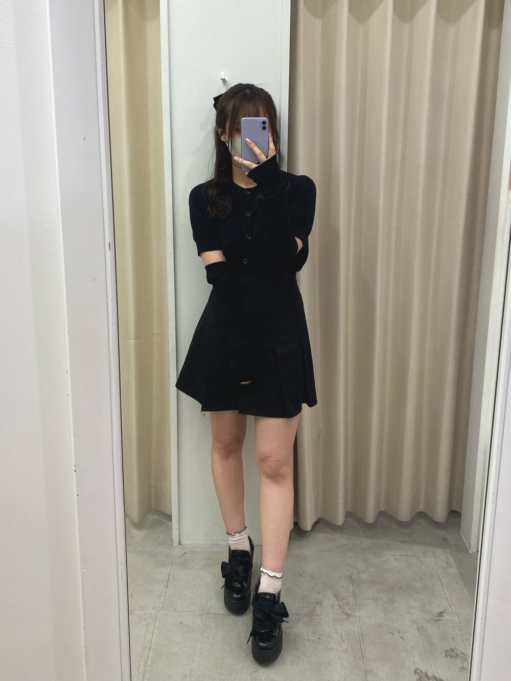 ブラック系のニット/セーター、ブラック系のスカートを着用したレディースの春コーディネートの3枚目の写真