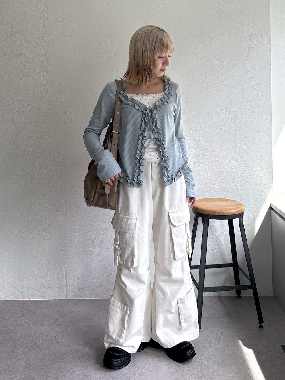 ブルー系のTシャツ/カットソー、ホワイト系のデニムパンツ、ブラウン系のトートバッグを着用したレディースの春コーディネートの3枚目の写真