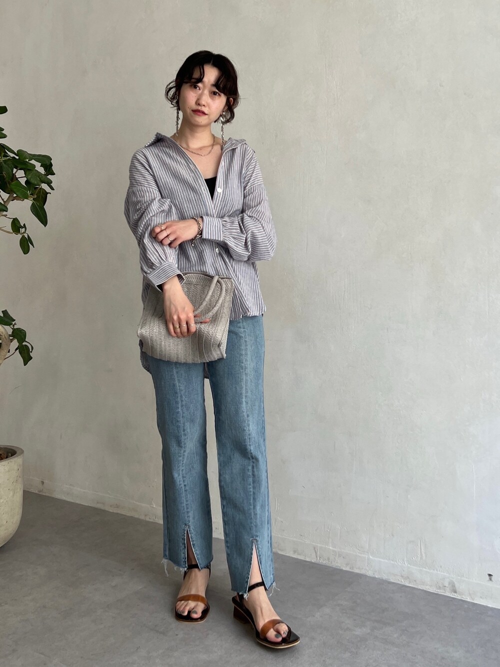 ブルー系のシャツ/ブラウス、ブルー系のデニムパンツ、グレー系のかごバッグを着用したレディースの春コーディネートの2枚目の写真