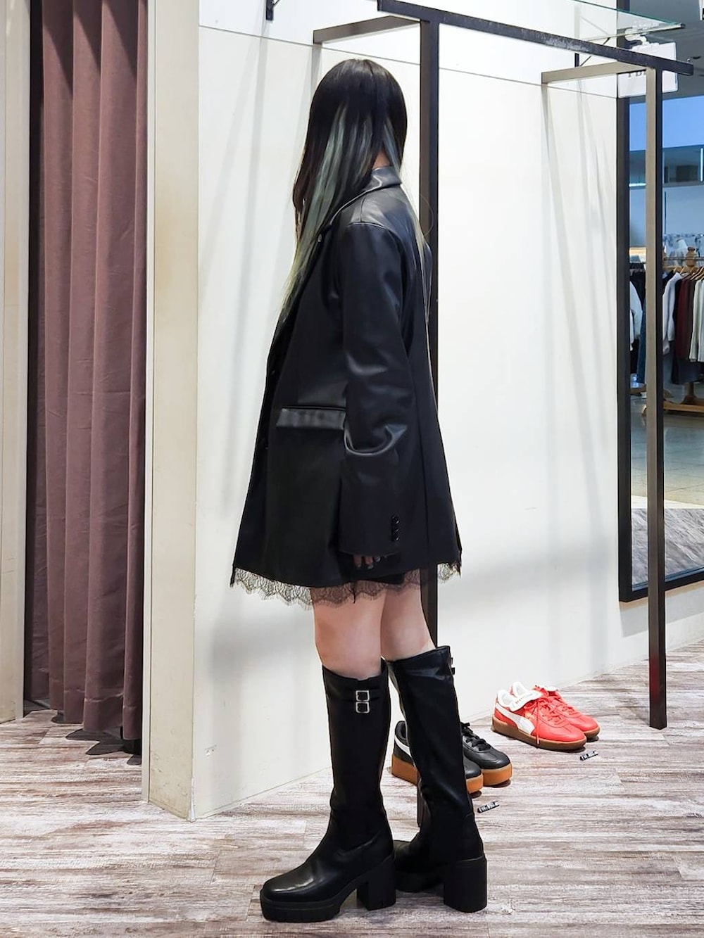 ブラック系のテーラードジャケット、ブラック系のニット/セーター、ブラック系のブーツを着用したレディースの秋コーディネートの5枚目の写真