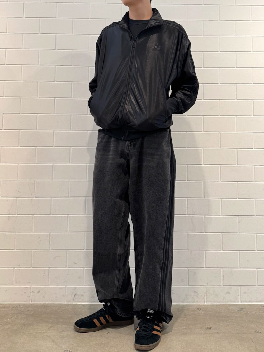 ブラック系のデニムパンツ、ブラック系のジャージ、ブラック系のシューズを着用したメンズの秋コーディネートの2枚目の写真