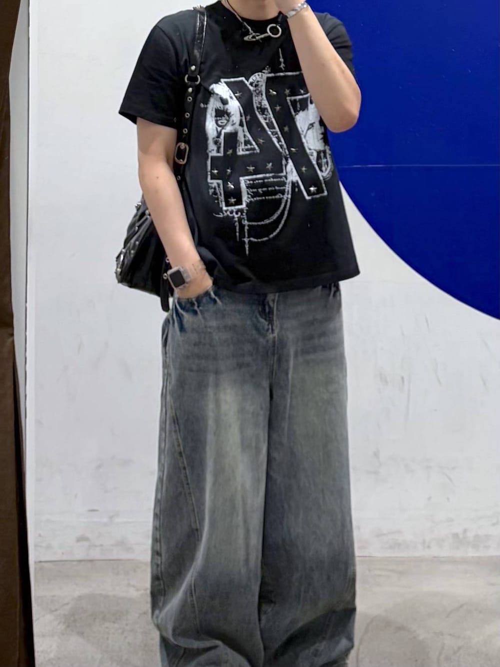 ブルー系のデニムパンツ、ブラック系のショルダーバッグ、ブラック系のTシャツ/カットソーを着用したメンズの夏コーディネートの2枚目の写真