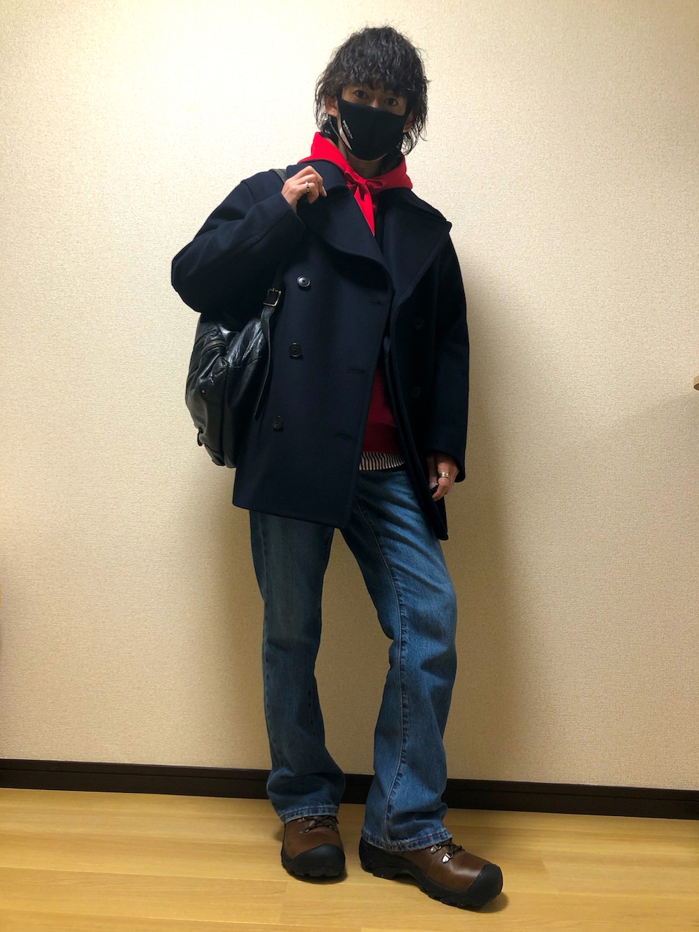 ブラウン系のブーツ、ブルー系のデニムパンツ、ブルー系のバックパック/リュックを着用したメンズの冬コーディネートの2枚目の写真