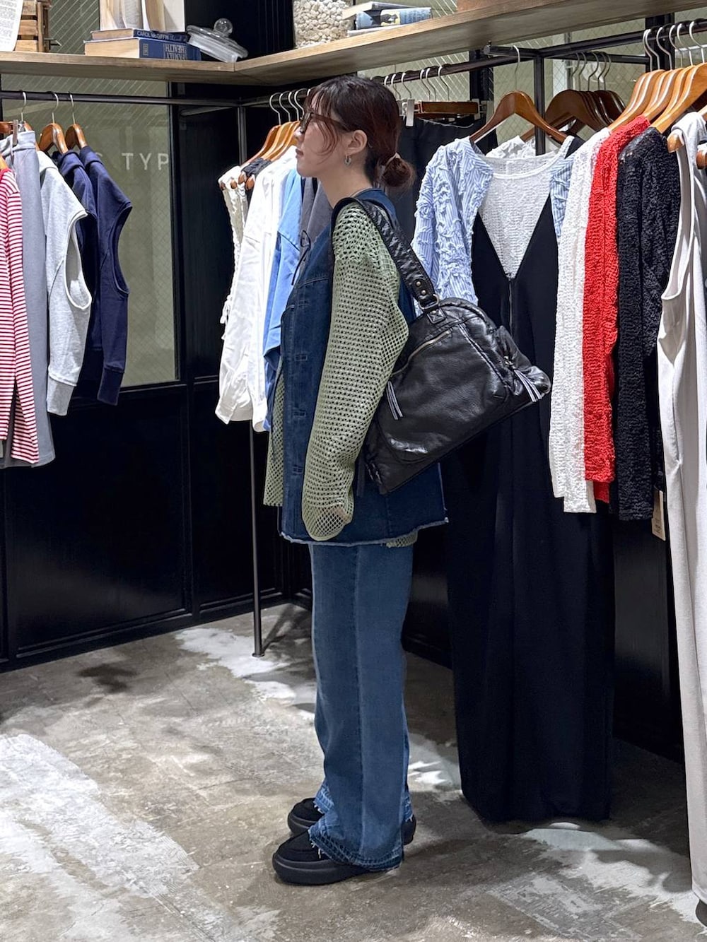 ブルー系のベスト、ブラック系のローファー、ブルー系のデニムパンツを着用したレディースの春コーディネートの2枚目の写真