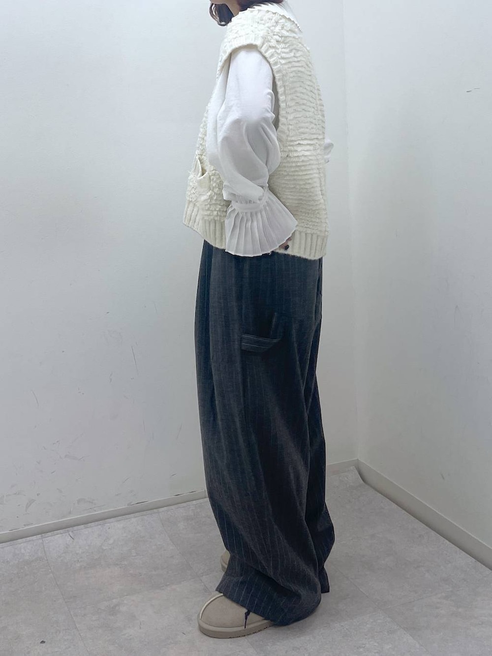 その他のスリッポン、グレー系のその他パンツ、ベージュ系のベストを着用したレディースの冬コーディネートの4枚目の写真