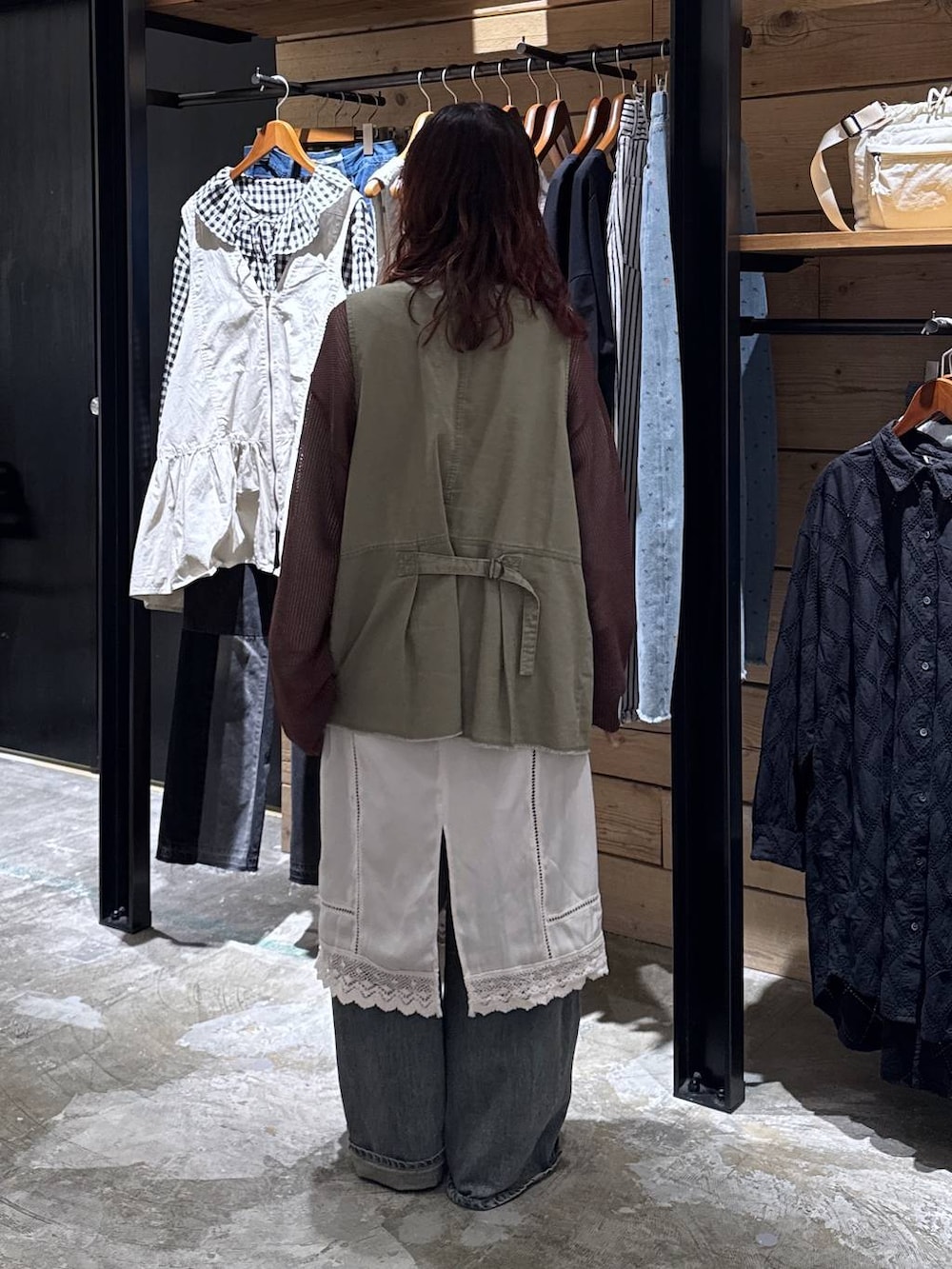 グリーン系のベスト、ブルー系のデニムパンツ、ベージュ系のTシャツ/カットソーを着用したレディースの春コーディネートの5枚目の写真