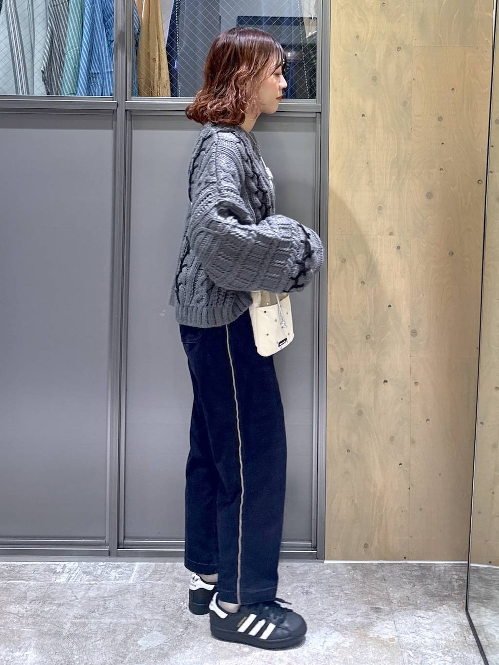 ホワイト系のショルダーバッグ、ブルー系のその他パンツ、グレー系のニット/セーターを着用したレディースの春コーディネートの6枚目の写真